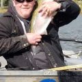 Mike Green of Doug Elliott hugging a fish 2018